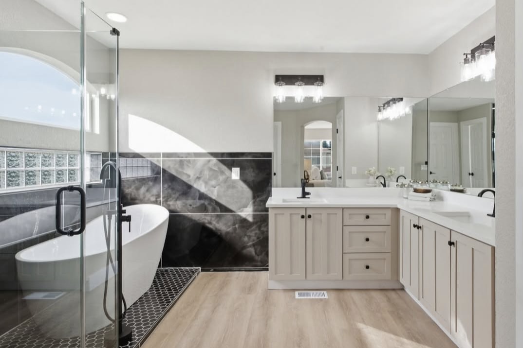 Primary bathroom with a freestanding tub, glass shower and double vanity