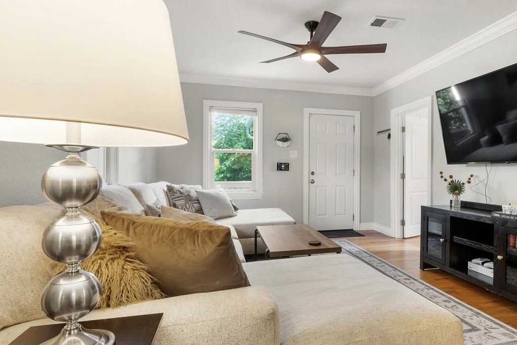 Living room with hardwood floors and crown molding