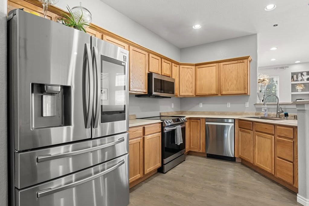 Kitchen with oak cabinets and stainless appliances