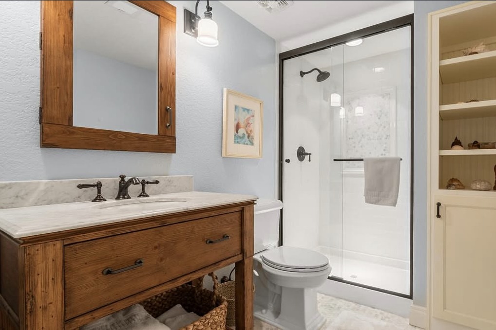 Bathroom with a wood vanity and walk-in shower
