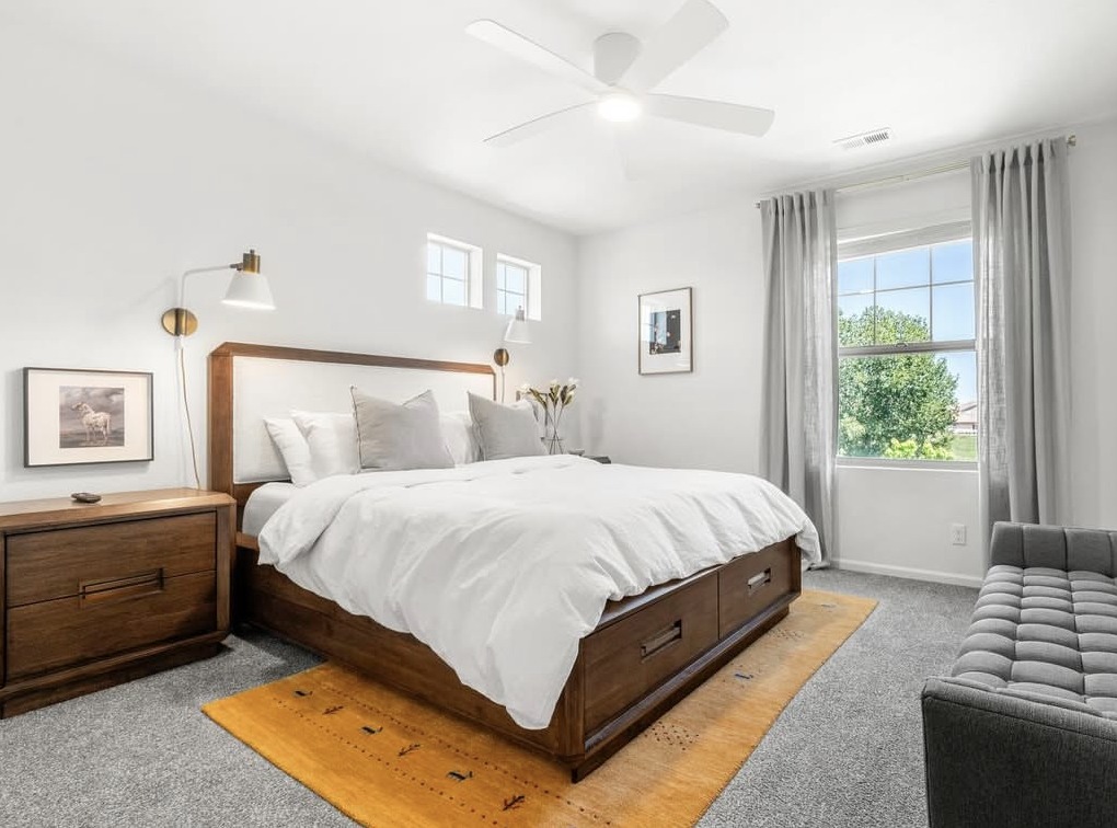 Primary bedroom with upholstered headboard and garden view in Aurora, CO