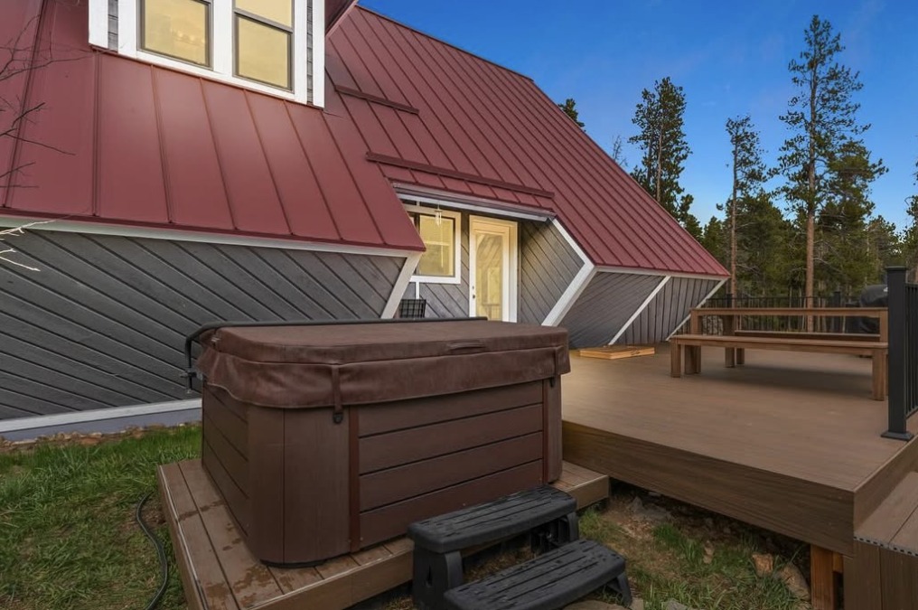 Mountain home hot tub and composite deck under blue sky in Black Hawk, CO