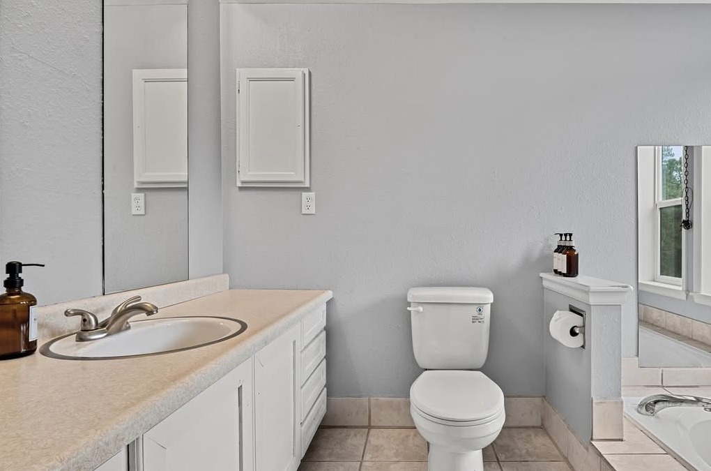 Bathroom vanity and toilet with tub alcove in Black Hawk, CO mountain home
