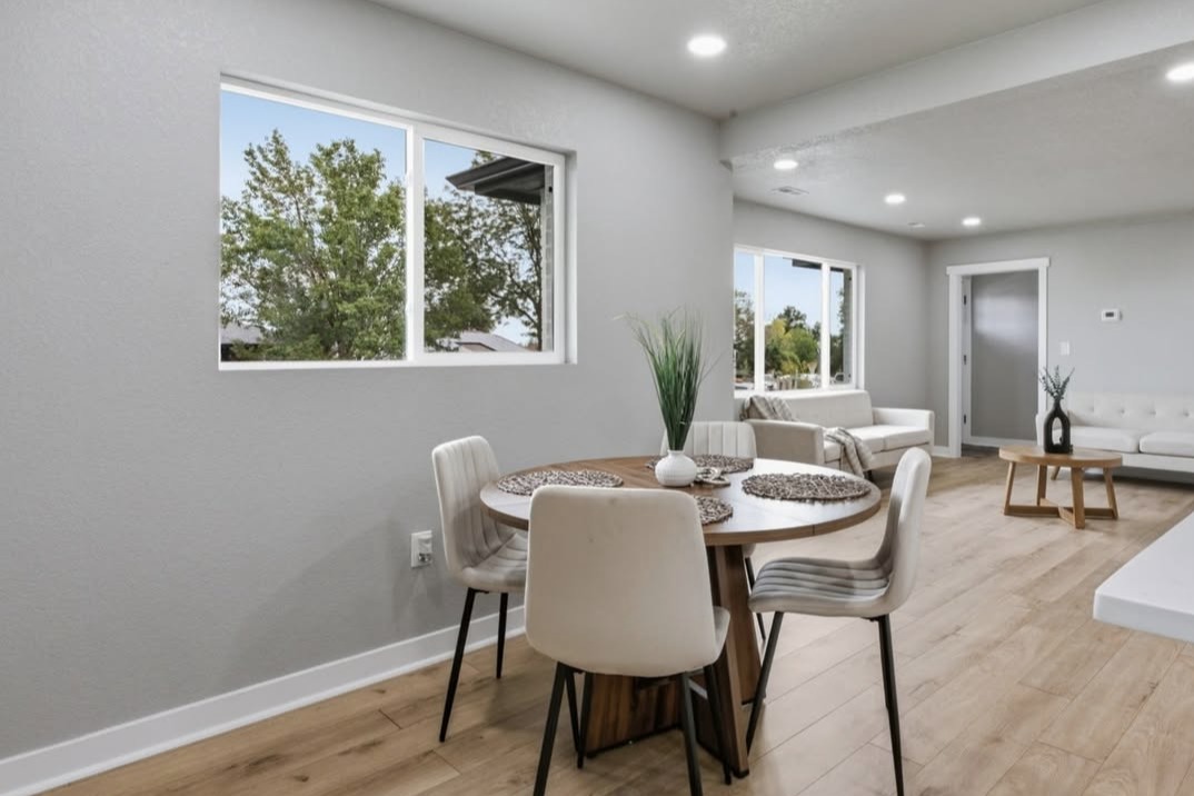 Open dining and living area with recessed lighting