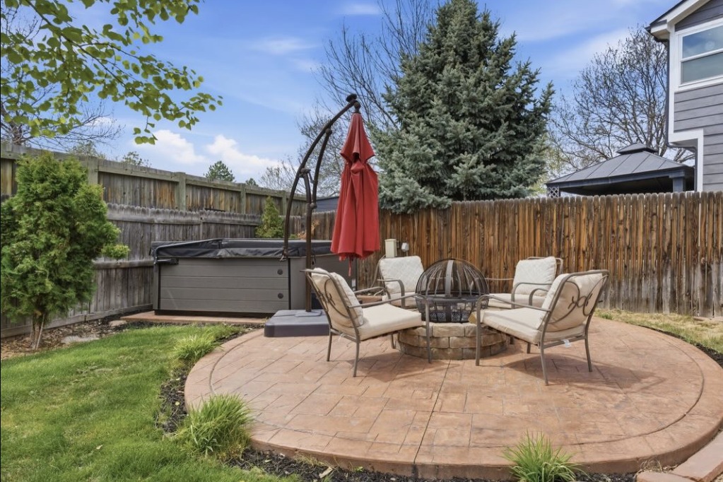 Backyard fire pit patio with a hot tub