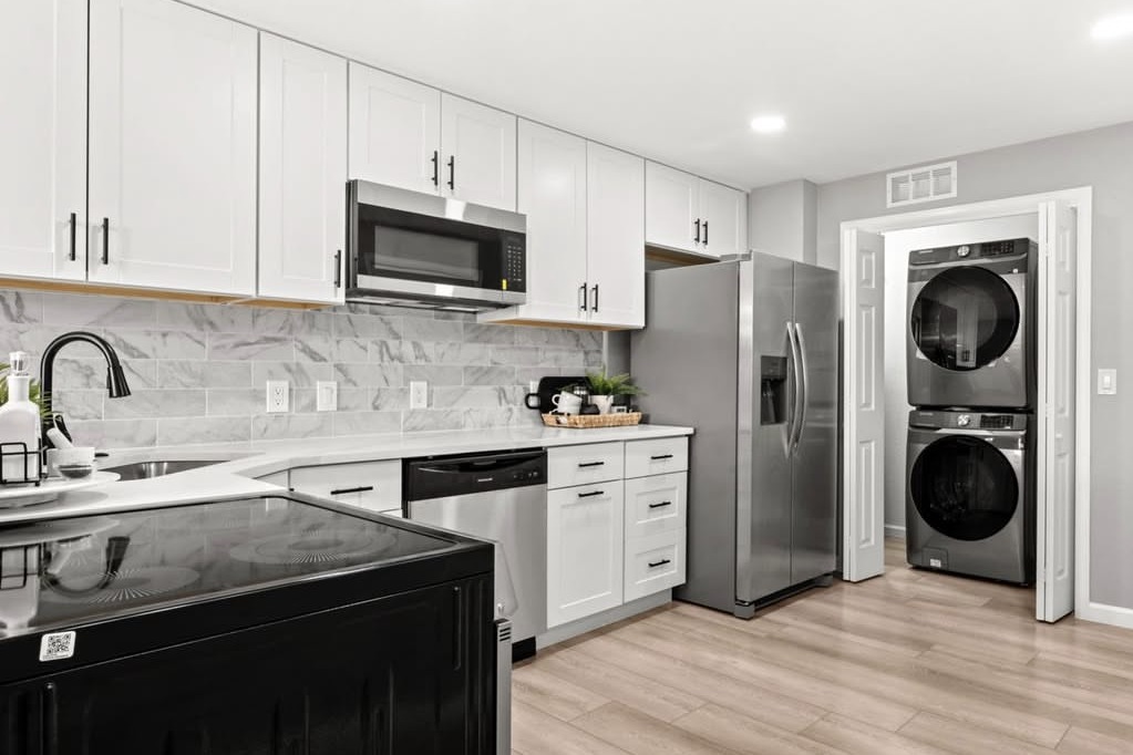 Kitchen with stainless appliances and a stacked laundry closet