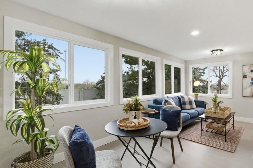 Sunroom with tall windows and a blue sofa
