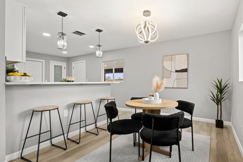 Dining area with a round table next to the breakfast bar