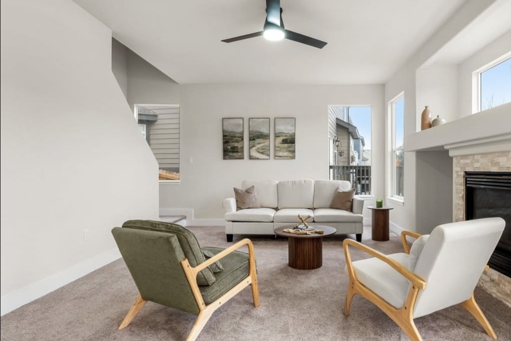 Staged living room with a stone fireplace