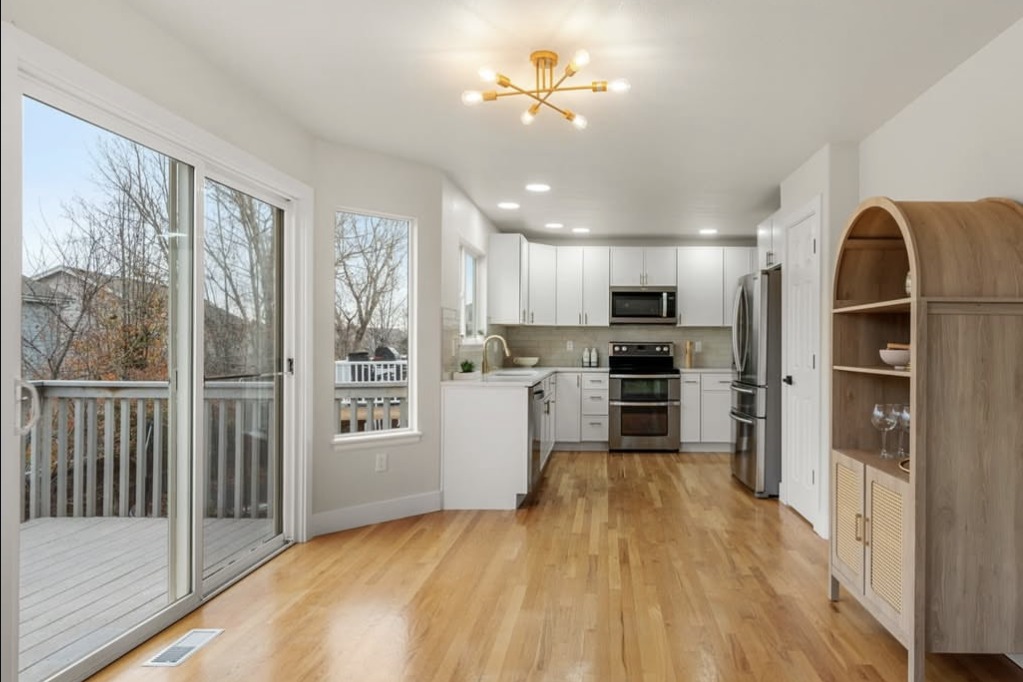 Dining area opening to the kitchen with a deck slider