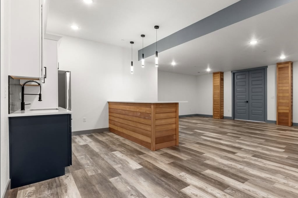 Finished basement with a wood bar and wet bar