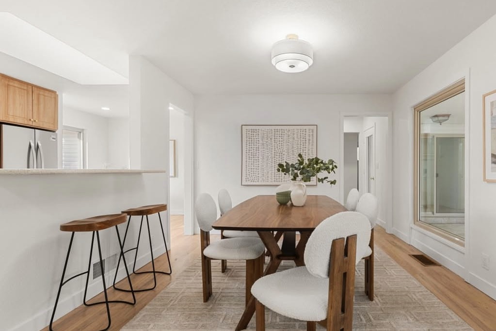 Dining room with a wood table next to the breakfast bar