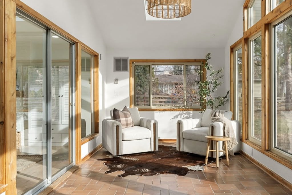 Sunroom with tile floors and two armchairs