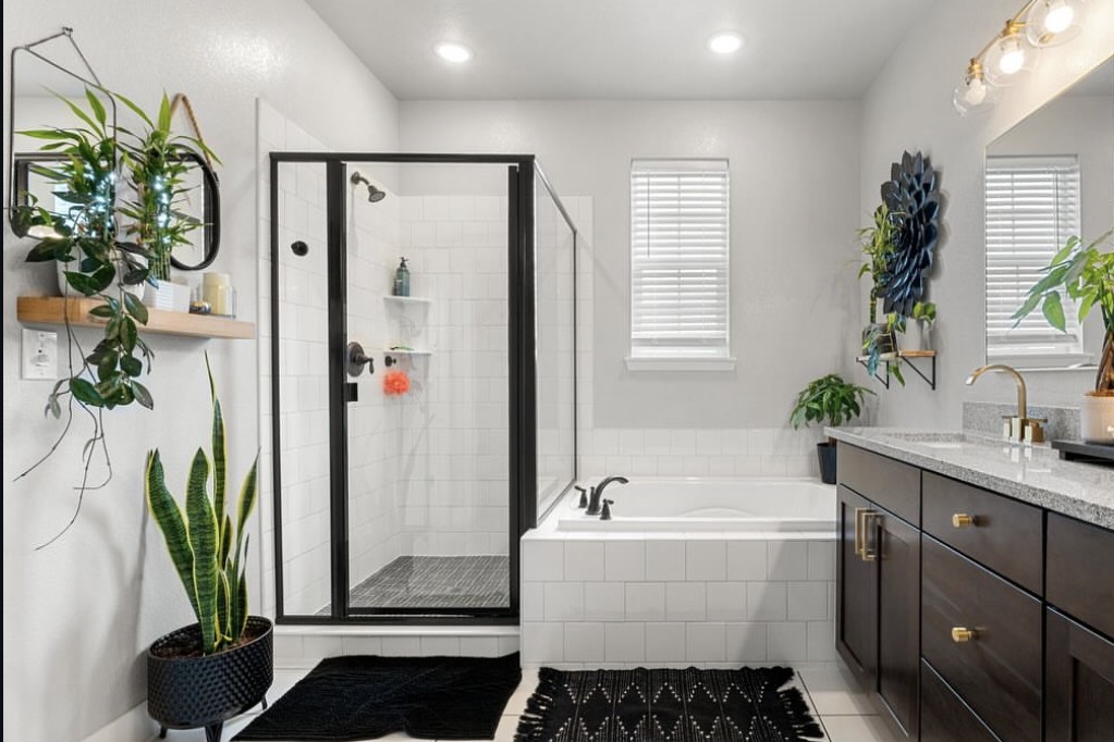 Primary bathroom with a soaking tub and dark vanity