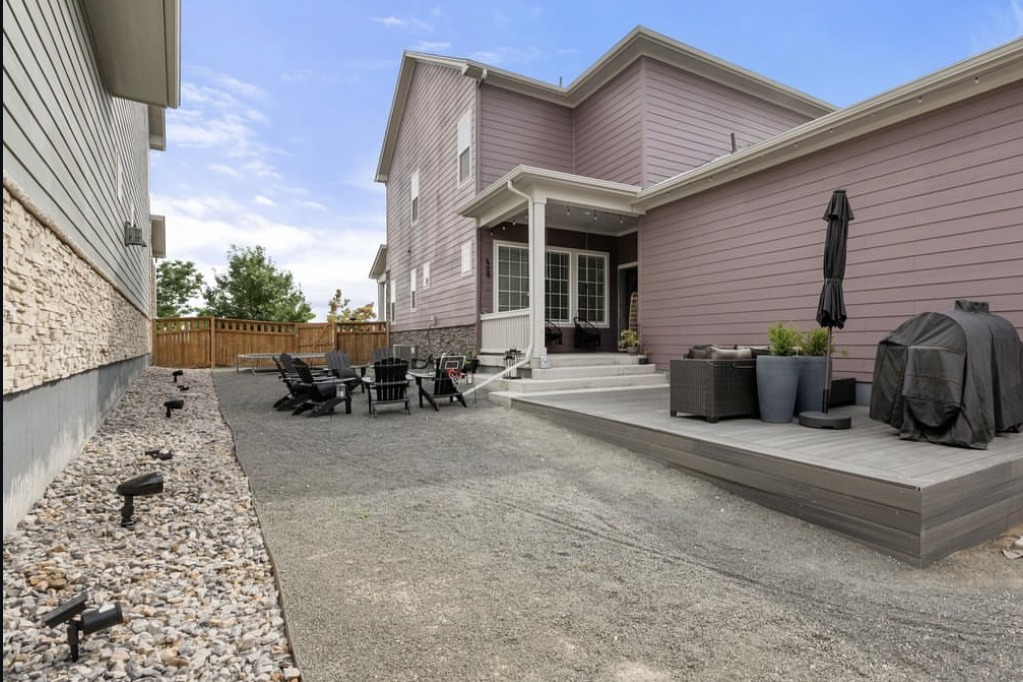 Backyard with a composite deck and gravel patio