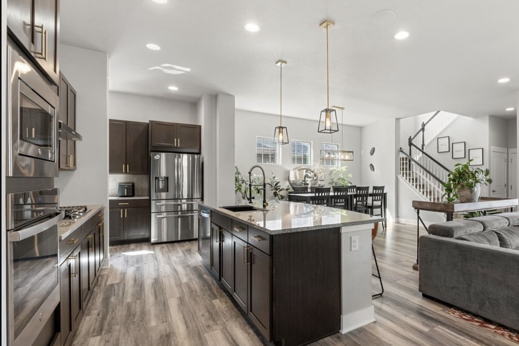 Open kitchen and living area with a granite island